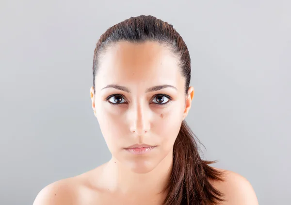 Beautiful woman face on grey background — Stock Photo, Image