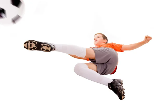 Boy kicking soccer ball, isolated on white — Stock Photo, Image