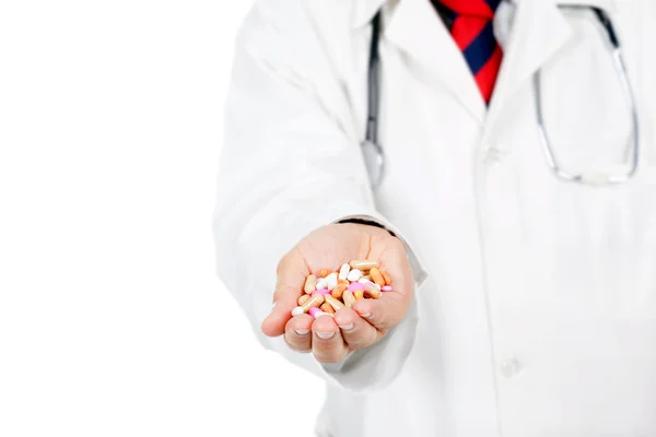 Doctor showing full hand of medical pills, isolated on white — Stock Photo, Image