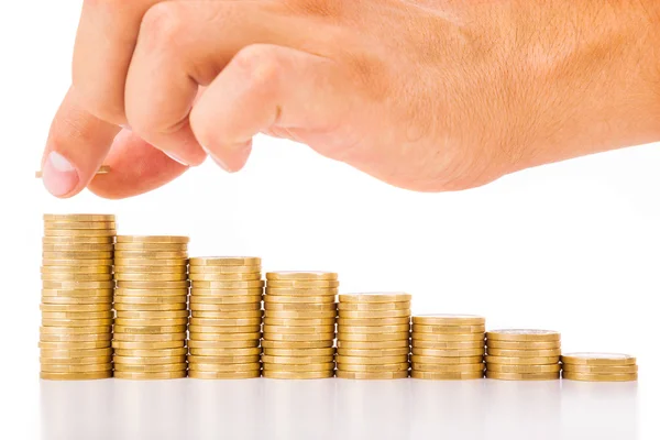 Hand put coin to money staircase , isolated on white — Stock Photo, Image