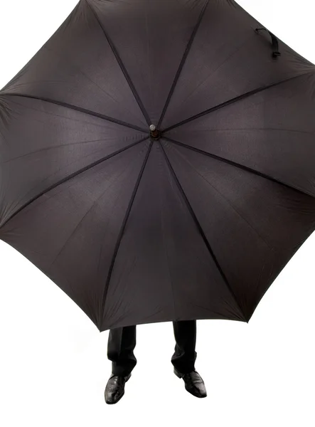 Business man hidden in umbrella against white background — Stock Photo, Image