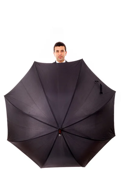 Affärsman gömd i paraply mot vit bakgrund — Stockfoto