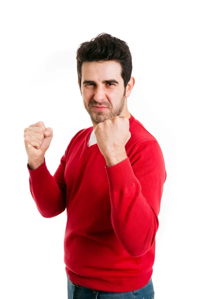 Portrait of young man winner gesture against a white background — Stock Photo, Image