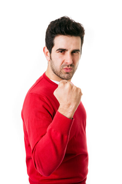 portrait of young man winner gesture against a white background