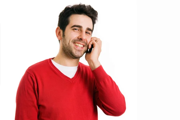 Young casual man talking on the phone isolated on white background — Stock Photo, Image