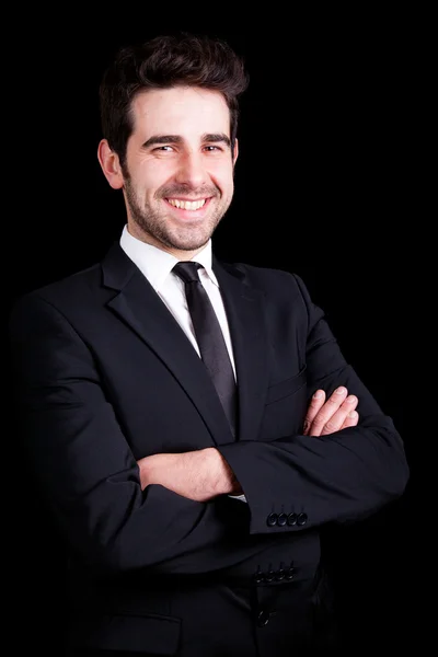 Portrait of a handsome young business man on black background — Stock Photo, Image