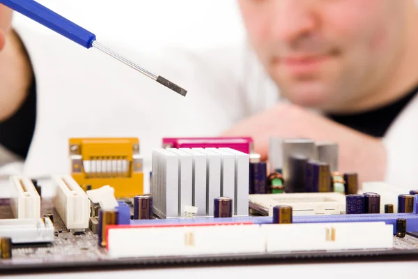 Computer Engineer examining, repairing a electronic circuit, isolated over white background — Stock Photo, Image