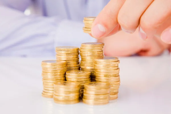 Business man put coins to money staircase — Stock Photo, Image