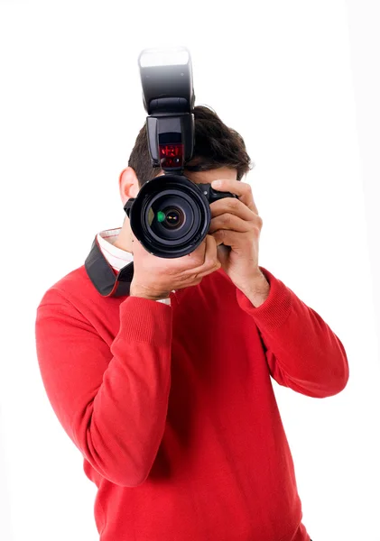 Joven fotógrafo con cámara sobre fondo blanco — Foto de Stock