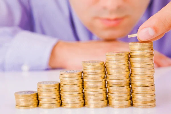 Business man rising coins Stock Image