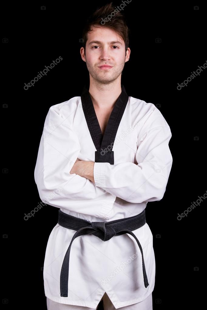 Portrait of young martial arts man on black background