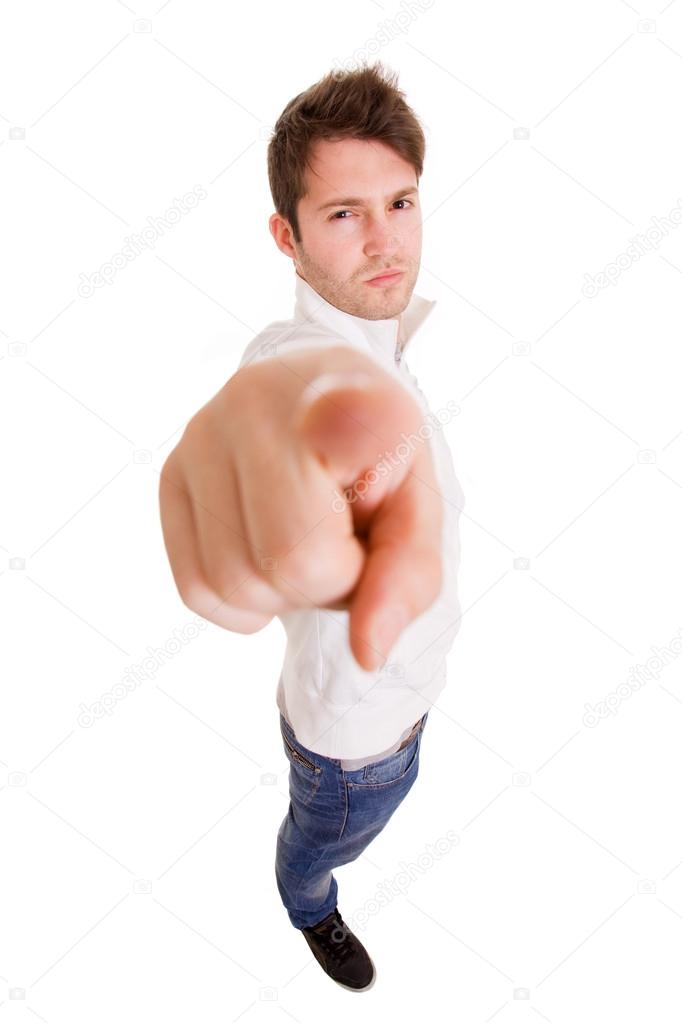 Full body portrait of a handsome young man pointing finger at you against white background