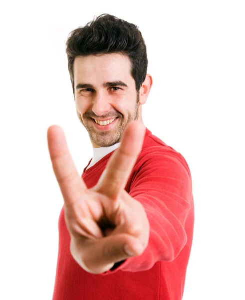 Sorrindo gesto jovem vencedor contra um fundo branco — Fotografia de Stock