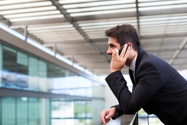 başarılı genç iş adamı modern cep telefonuyla konuşuyor