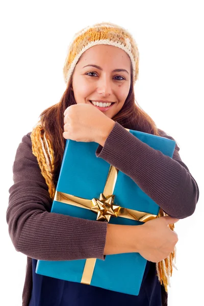 Beautiful young woman holding a gift, isolated on white — Stock Photo, Image