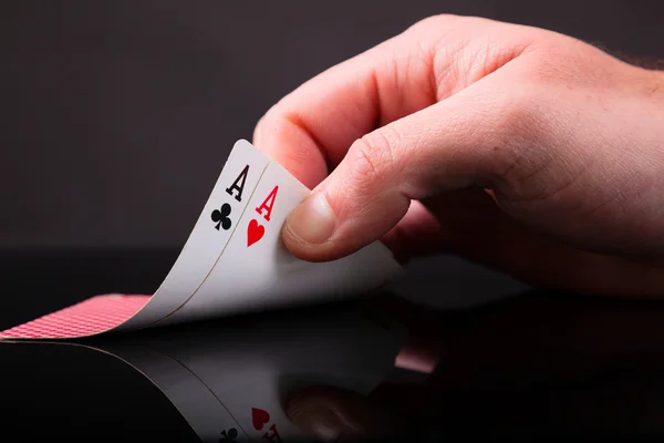 Two aces in the hand on black background — Stock Photo, Image