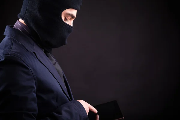 Closeup portrait of a hacker stealing data from digital tablet — Stock Photo, Image