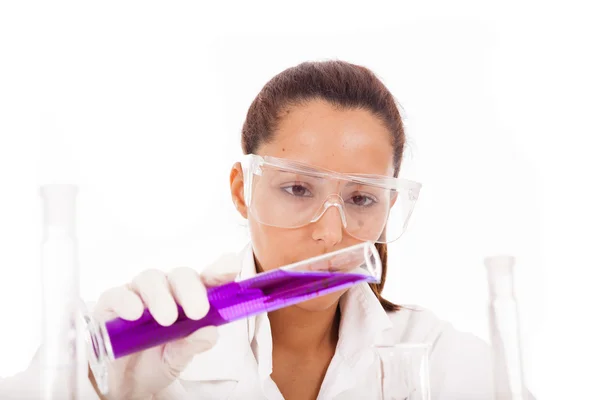 Female researcher checking a flask of liquid, isolated on white — Stock Photo, Image