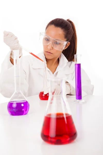 Female researcher checking test tubes, isolated on white — Stock Photo, Image