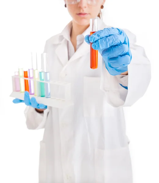 Young scientist holding a flask of liquid, isolated on white — Stock Photo, Image
