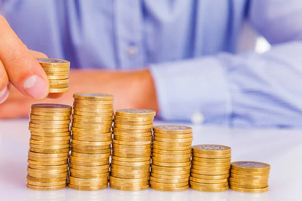 A Businessman rising coins — Stock Photo, Image
