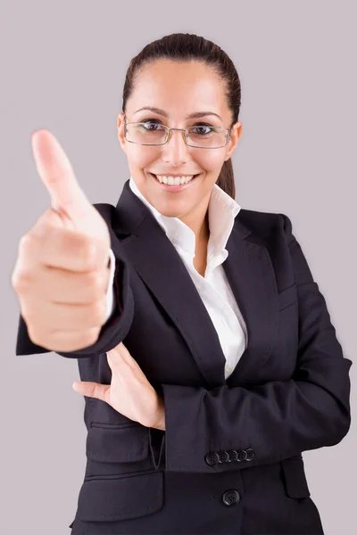 Portrait of a smiling business woman with thumbs up gesture on g Royalty Free Stock Photos