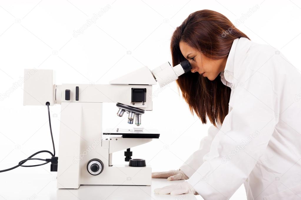 Female researcher looking through microscope, isolated on white