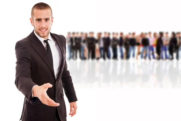 Smiling young businessman with an open hand ready to seal a deal — Stock Photo, Image