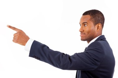 Happy African American businessman pointing at copy space agains clipart