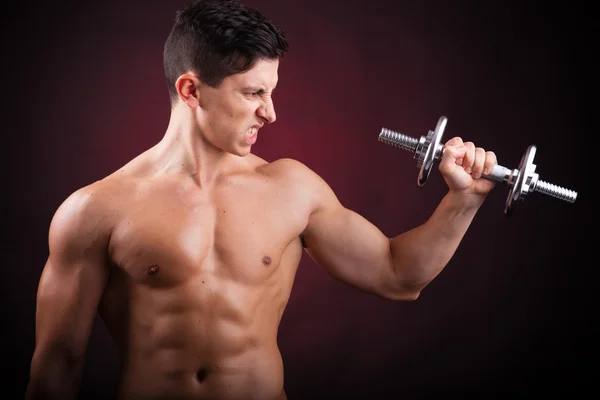 Image of a muscular young man lifting weights on black backgroun — Stock Photo, Image