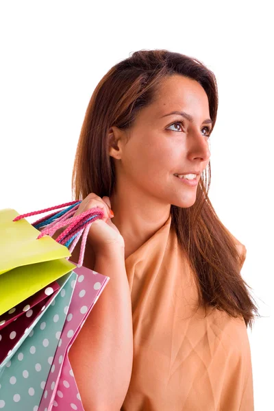 Retrato de una hermosa mujer sosteniendo bolsas de compras contra Whit — Foto de Stock