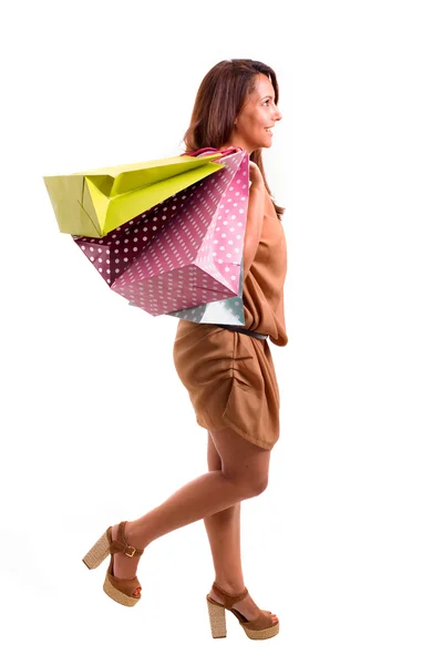 Mulher bonita com lotes de sacos de compras andando sobre whit — Fotografia de Stock