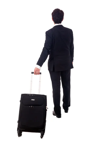 Joven hombre de negocios caminando sobre fondo blanco con su viaje b — Foto de Stock