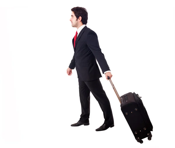 Joven hombre de negocios caminando sobre fondo blanco con su viaje b — Foto de Stock