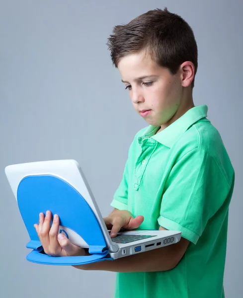 Boy with laptop on grey background — Stock Photo, Image