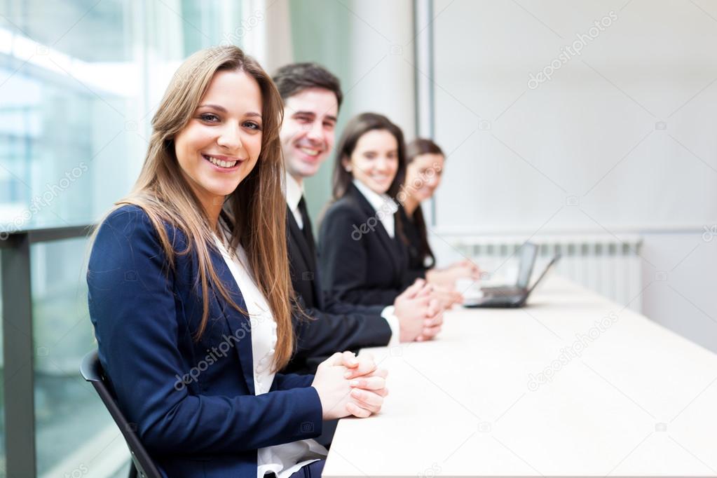 Group of business smiling at the office lined up