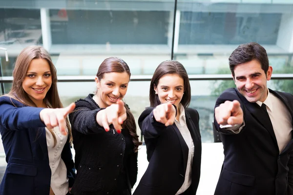 Businesspeople pointing at you and smiling — Stock Photo, Image