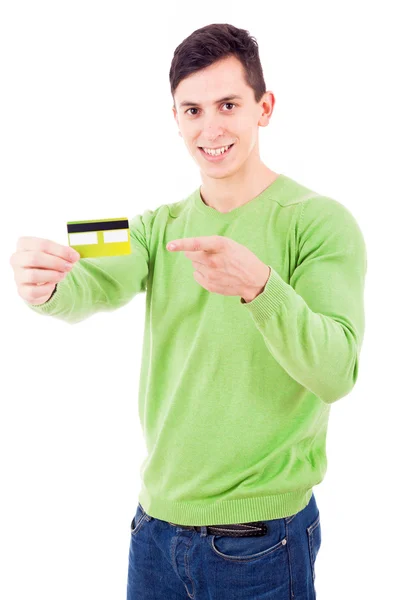 Joven sonriente apuntando a la tarjeta de crédito sobre fondo blanco —  Fotos de Stock