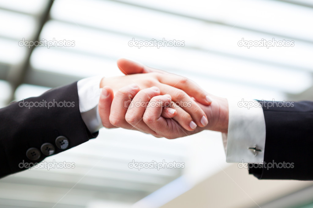Business handshaking closing a deal
