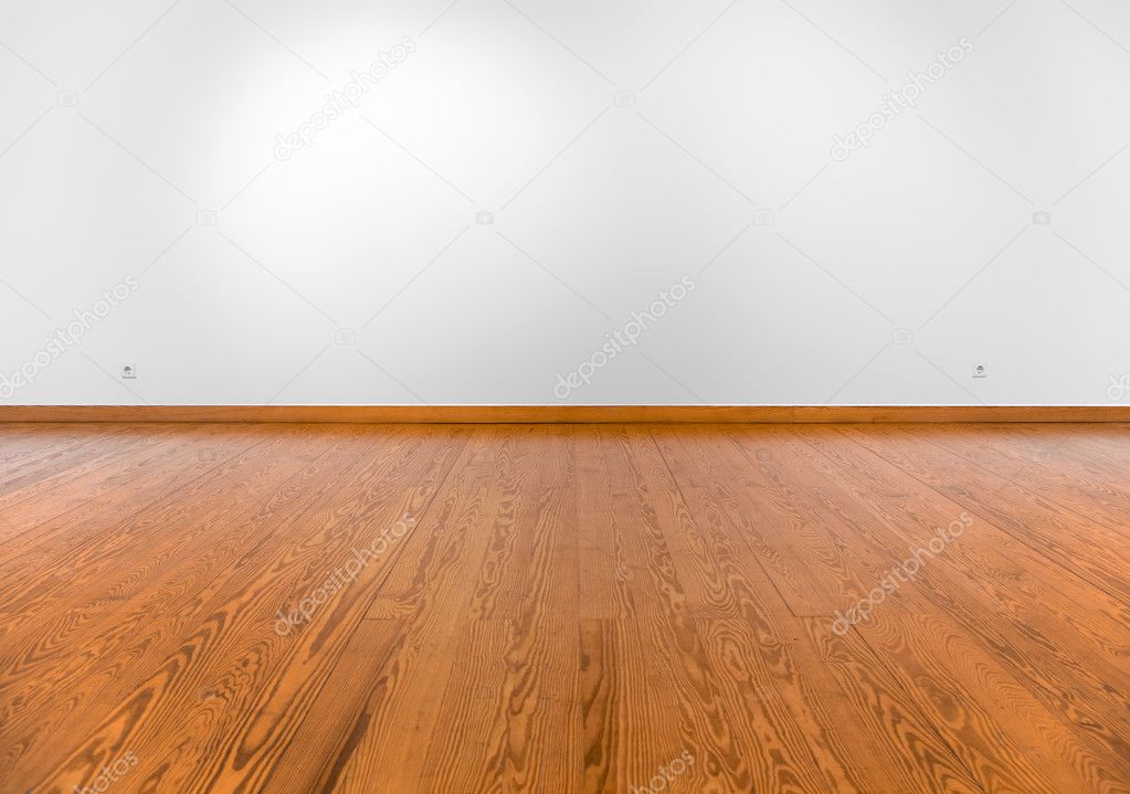 Empty white wall with spot lights and wooden floor