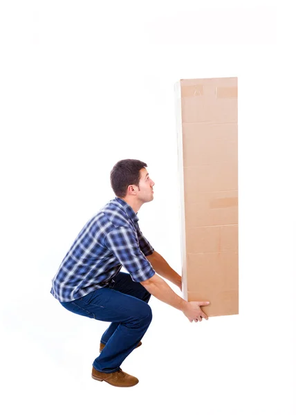 Young man lifting a cardboard box, isolated on white background — Stock Photo, Image