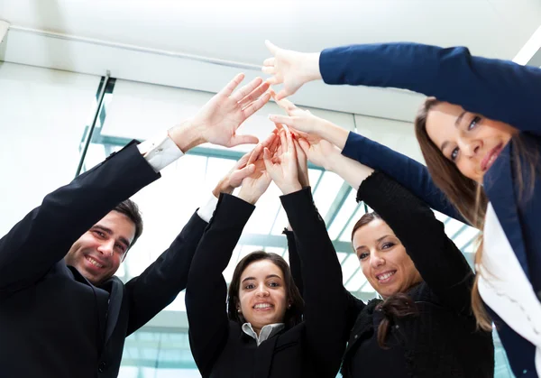 Group of smiling businesspeople giving high-five — Stock Photo, Image