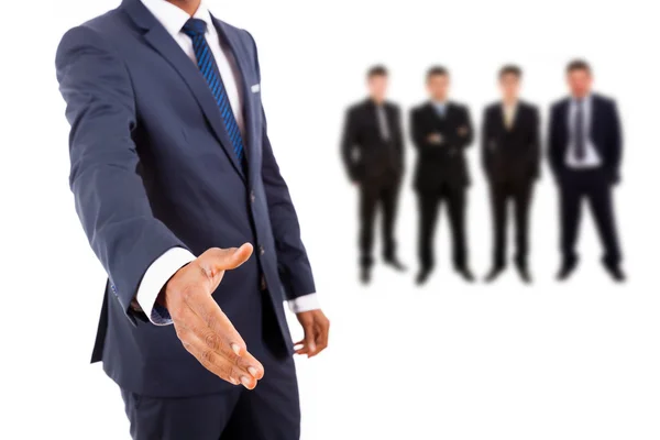 Business man offering handshake with businesspeople — Stock Photo, Image