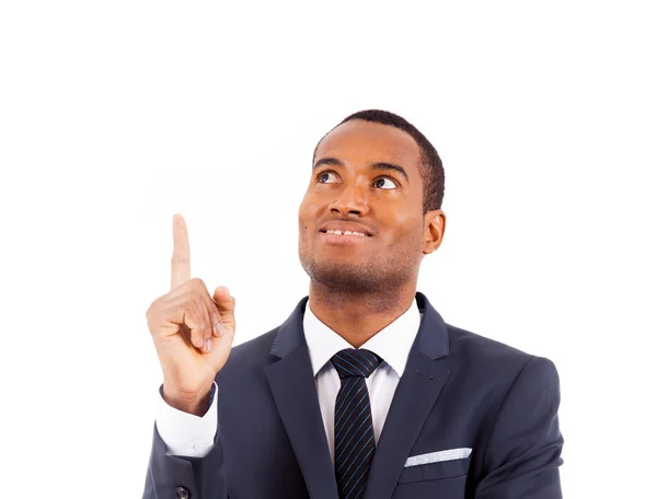 Portrait of happy African American businessman pointing upwards — Stock Photo, Image