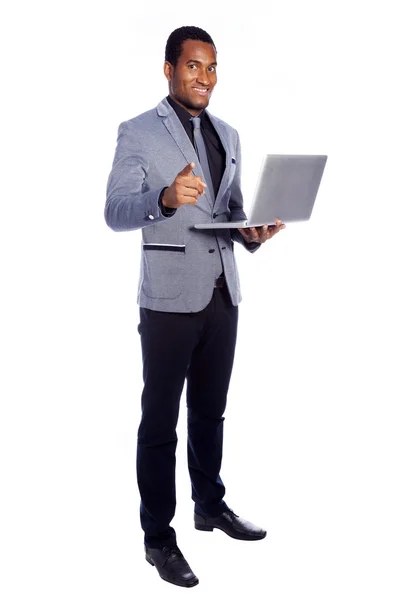 Hombre de negocios sonriente sosteniendo una computadora portátil —  Fotos de Stock