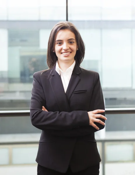 Portrait of a happy smiling young business woman with cross-arme — Stock Photo, Image