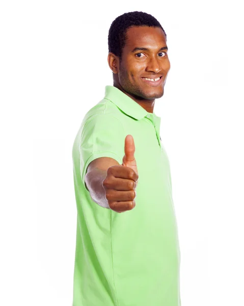 Young casual man thumbs up and looking at the camera, isolated o — Stock Photo, Image