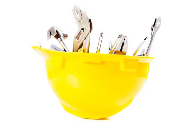 Yellow helmet and tools isolated over white background — Stock Photo, Image