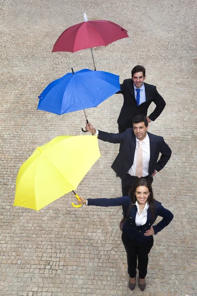 Деловые люди с зонтиками — стоковое фото