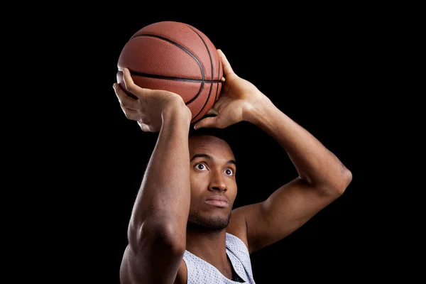 Basketball player against dark background — Stock Photo, Image